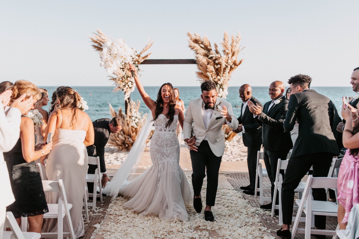 A neutral glam beach wedding with candles, pampa grass   disco balls