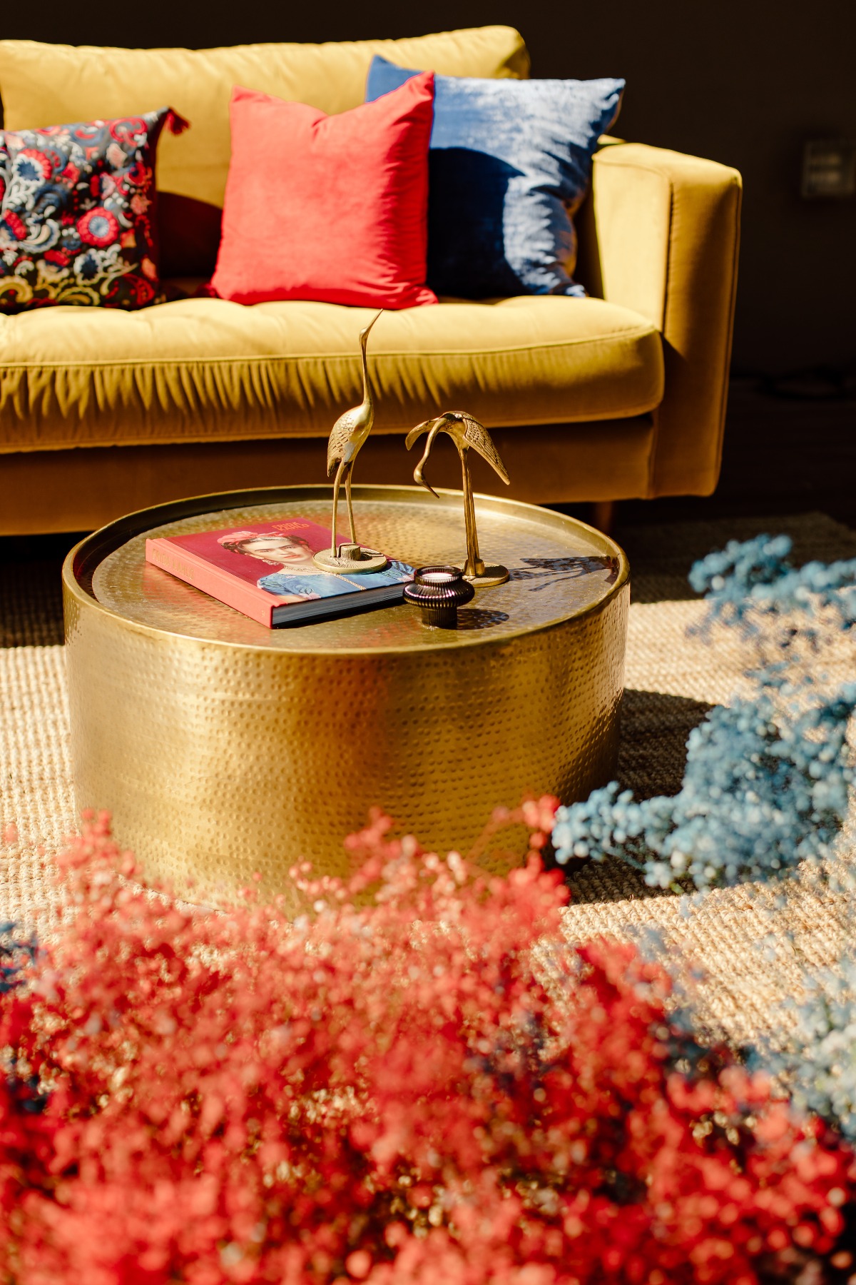Bright living room with gold table and colorful accents
