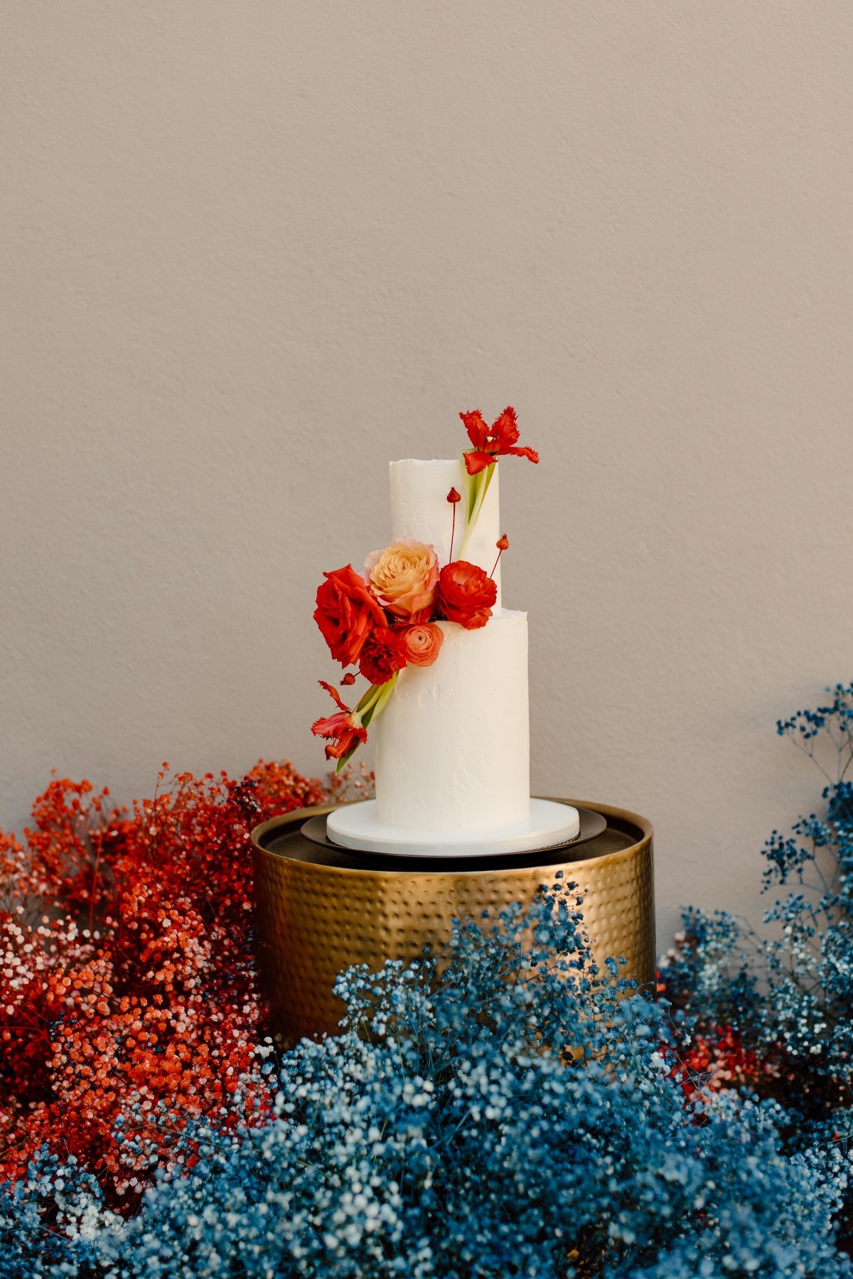 Two tier wedding cake with colorful flower decoration