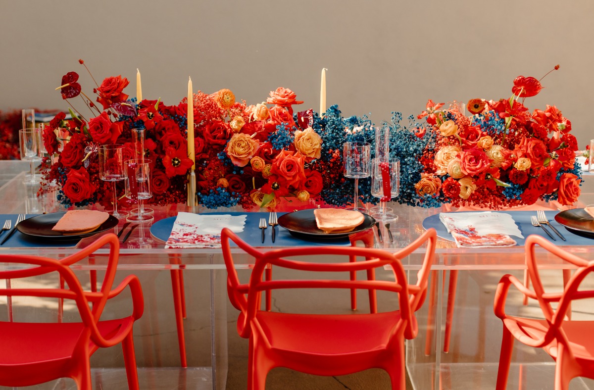 Elegant floral tablescape with red chairs roses etc