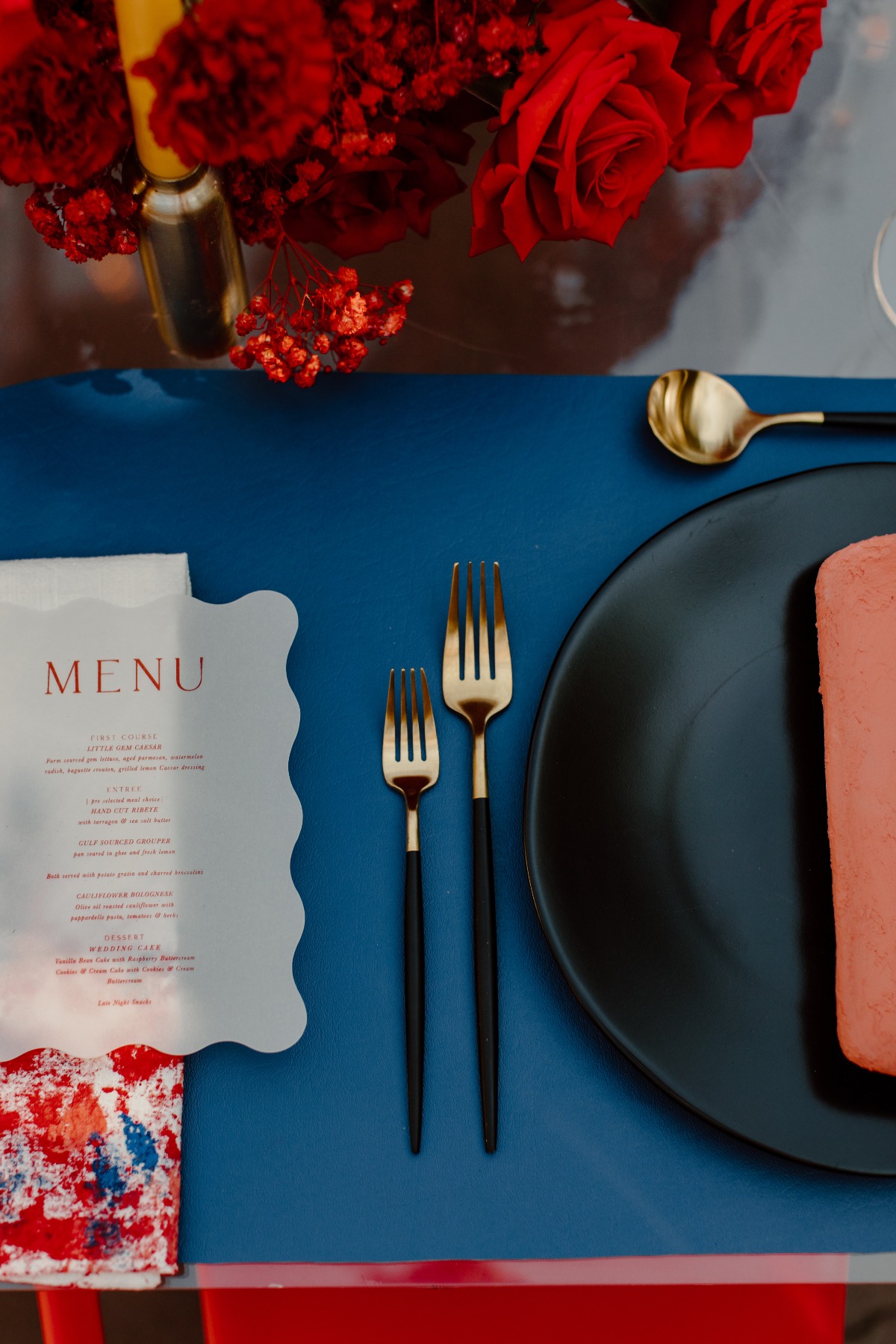 Elegant table setting with menu flowers and blue mat