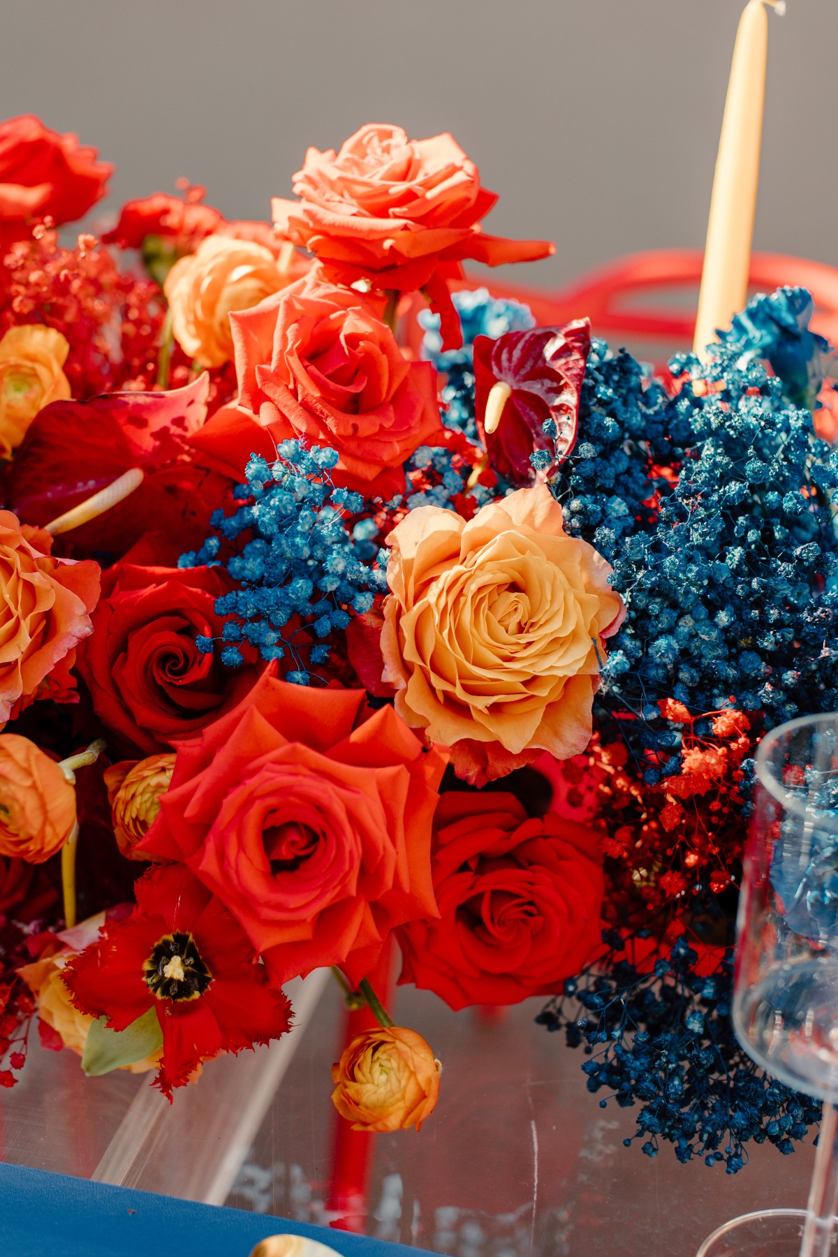 Vibrant floral arrangement with red roses and blue accents