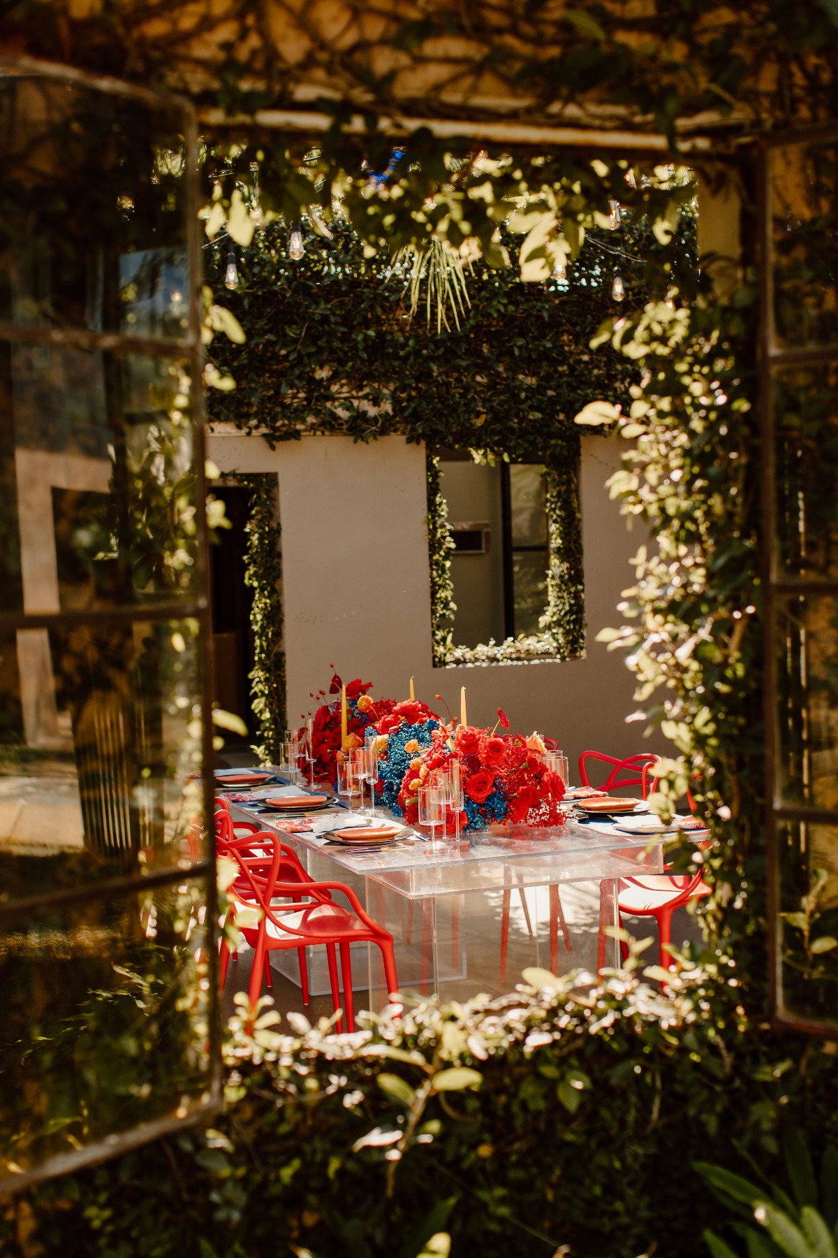 Garden view of red chairs and a floral decorated table