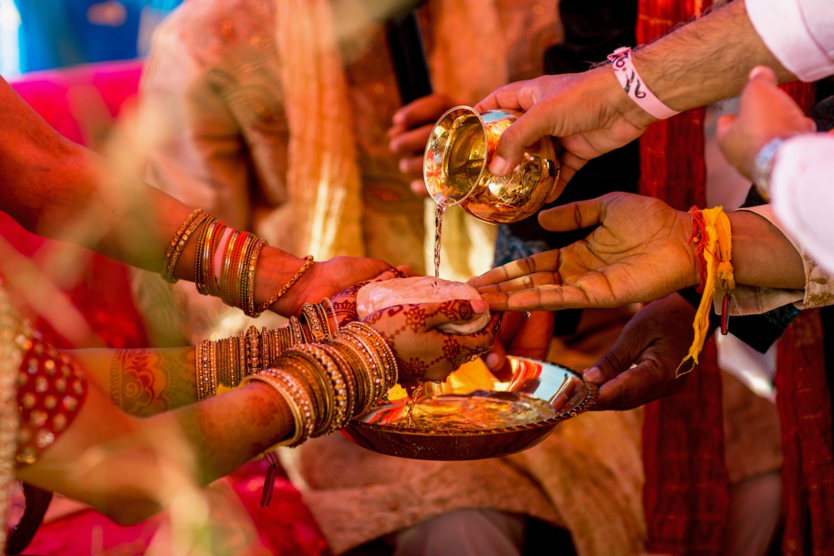 Water being poured during traditional Hindu wedding ceremony