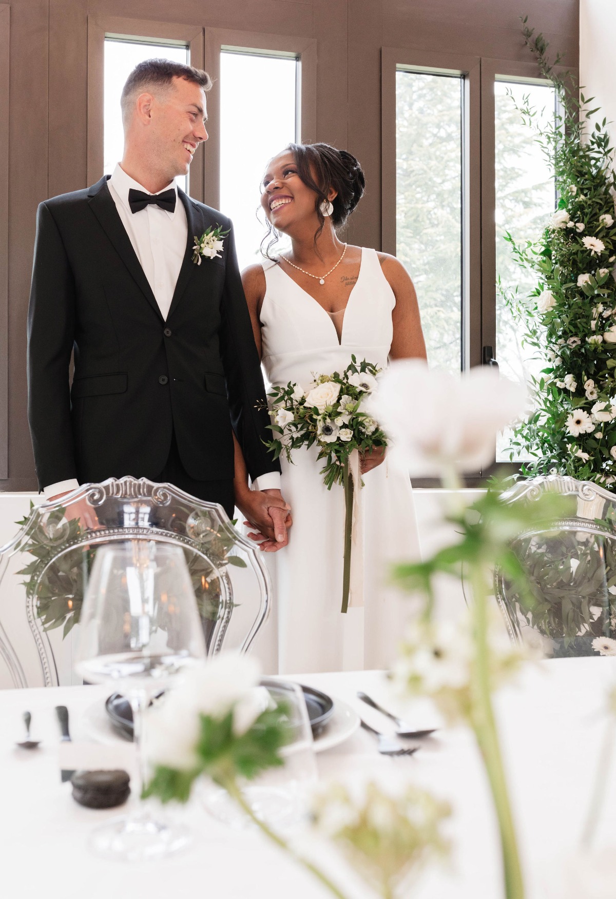 Bride looking at groom behind sweetheart table at reception