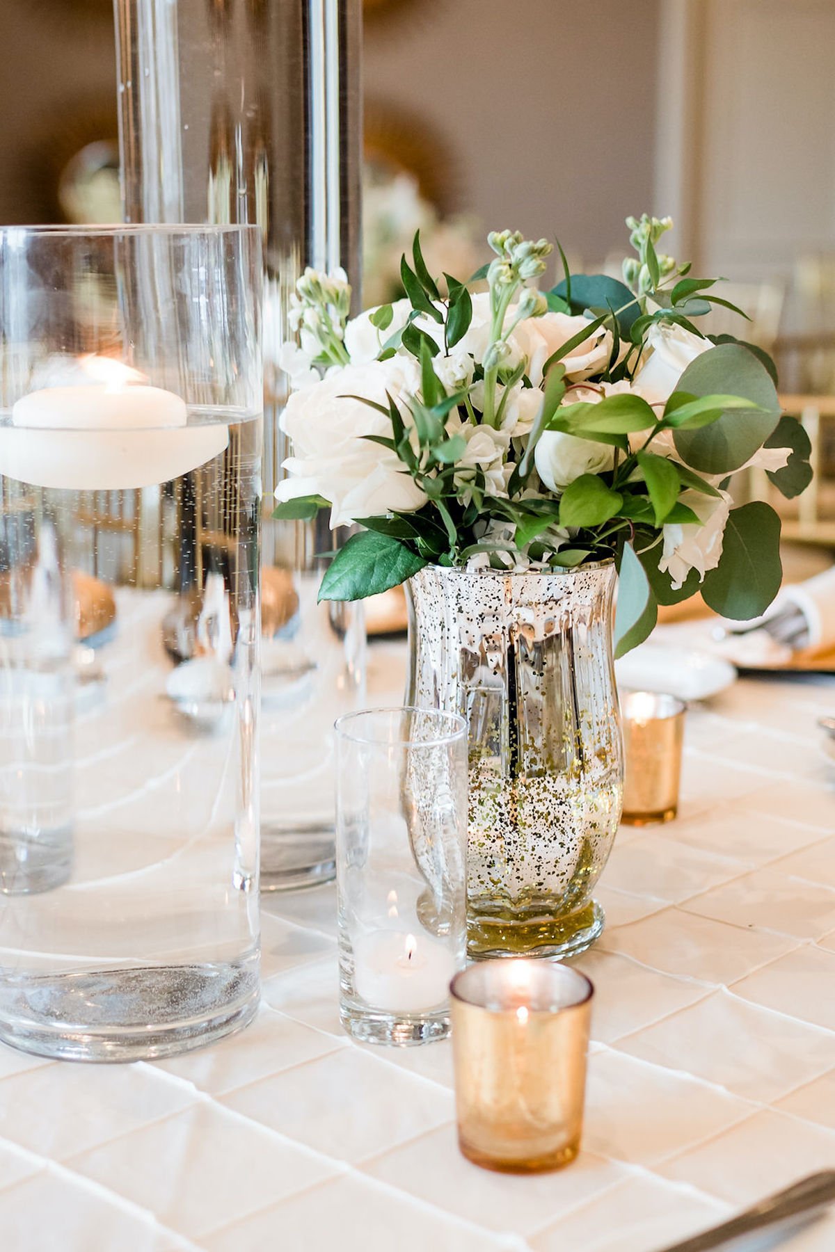 Reception centerpiece with floating candles and flowers