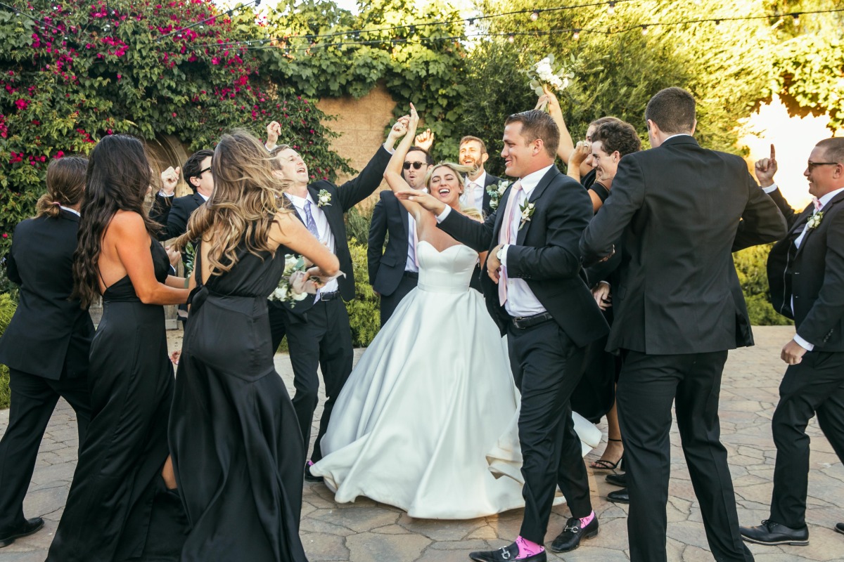 Bride and groom dancing with wedding party