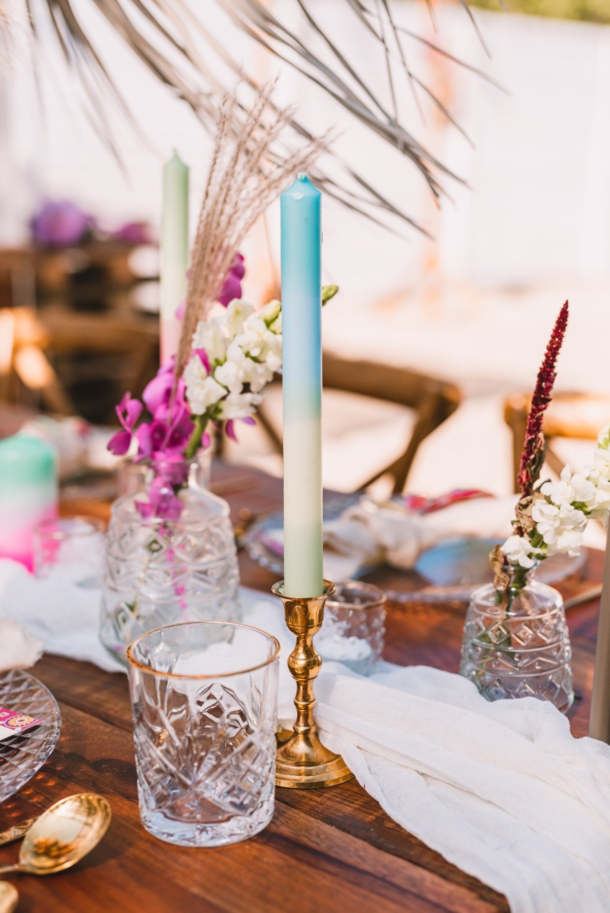 Close up of centerpiece table runner, candle, and glasses