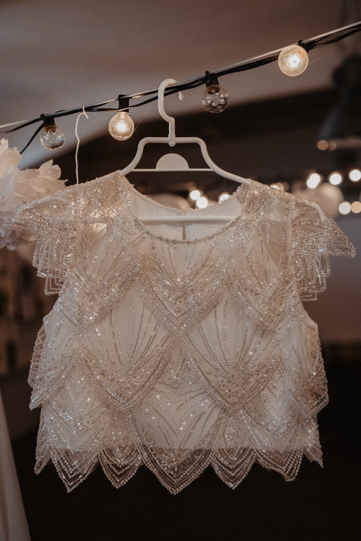 Close up of bridal top hanging on light strand