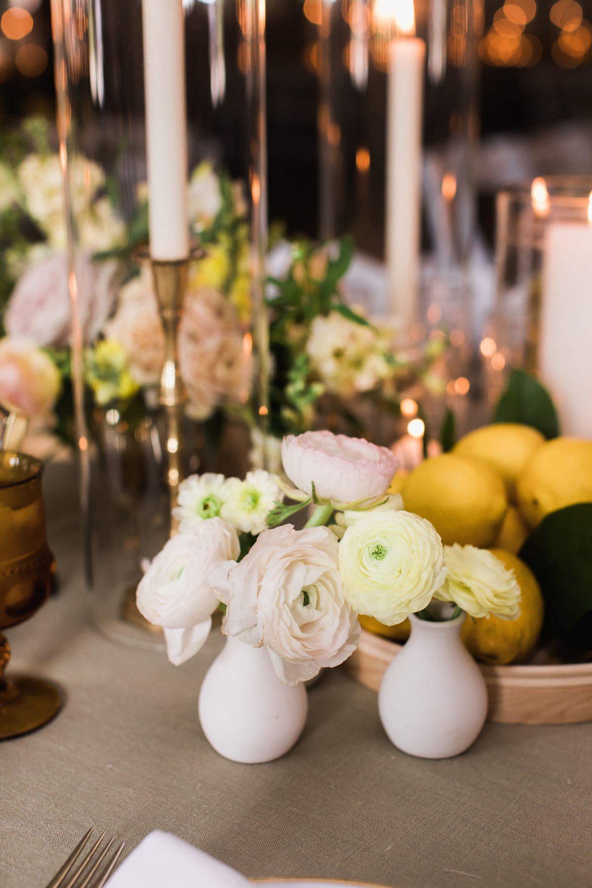 Easy wedding floral arrangement ideas use small vases filled with Sinnias