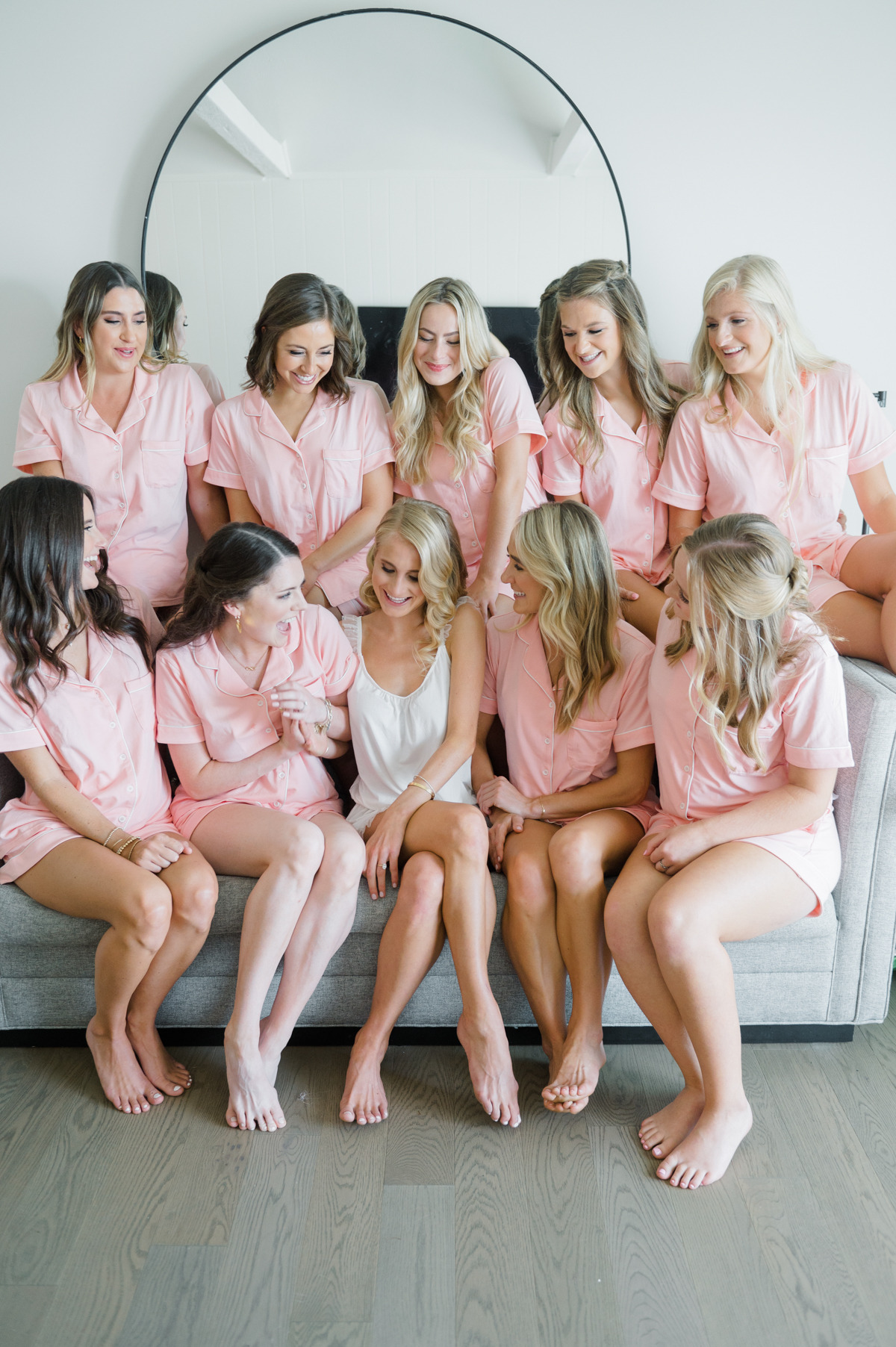 Bride surrounded by bridesmaids in pink matching pajama sets