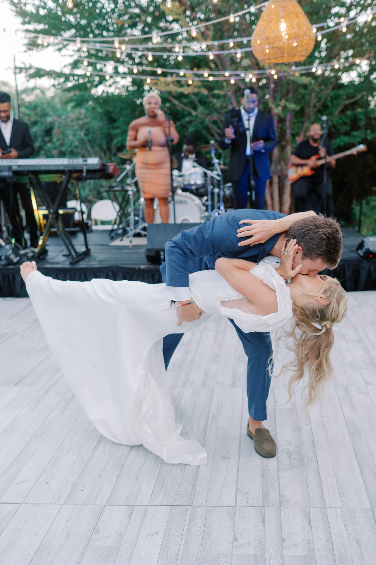 Groom dipping bride to kiss her on dance floor