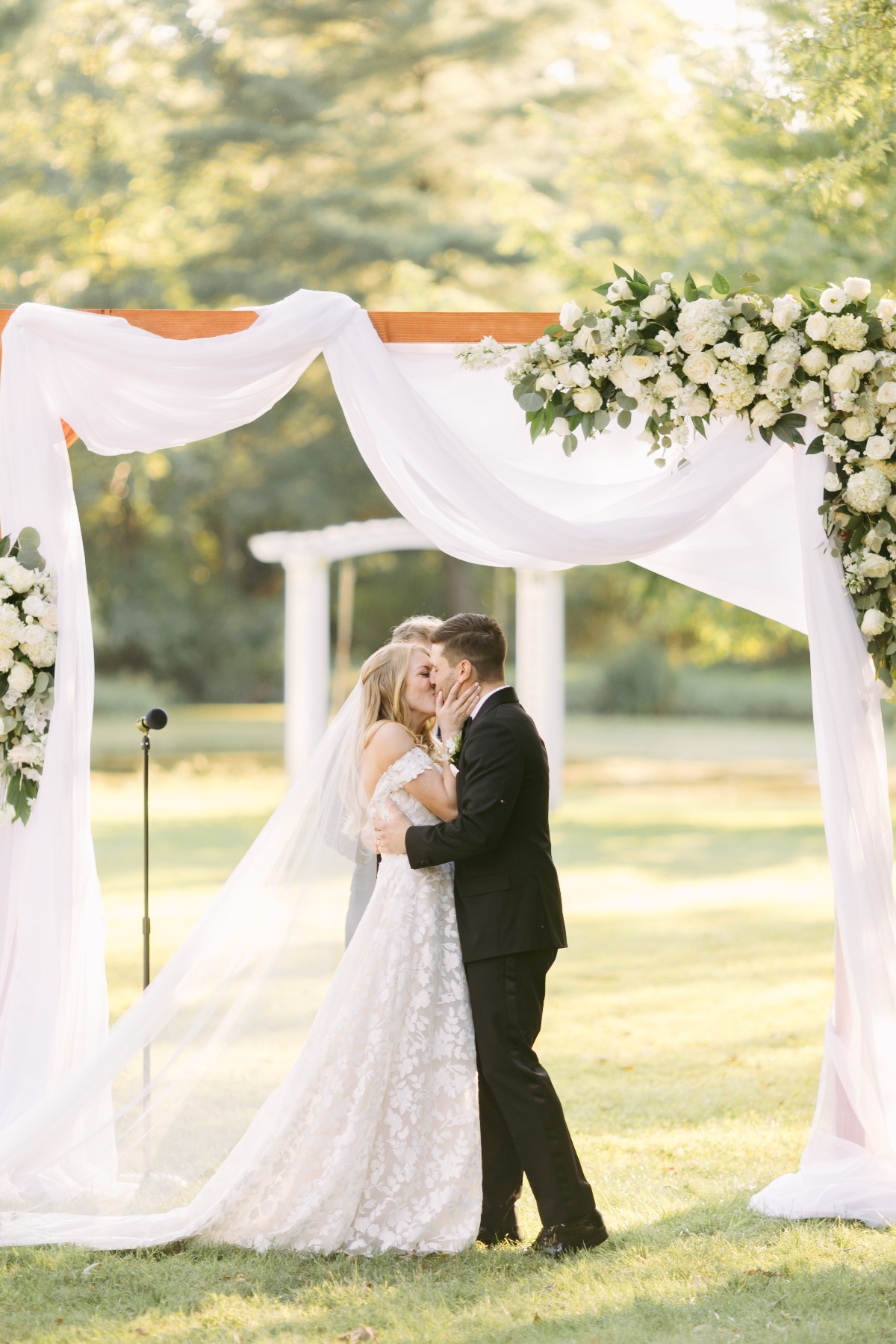 Bride and groom kissing in front of altar during ceremony