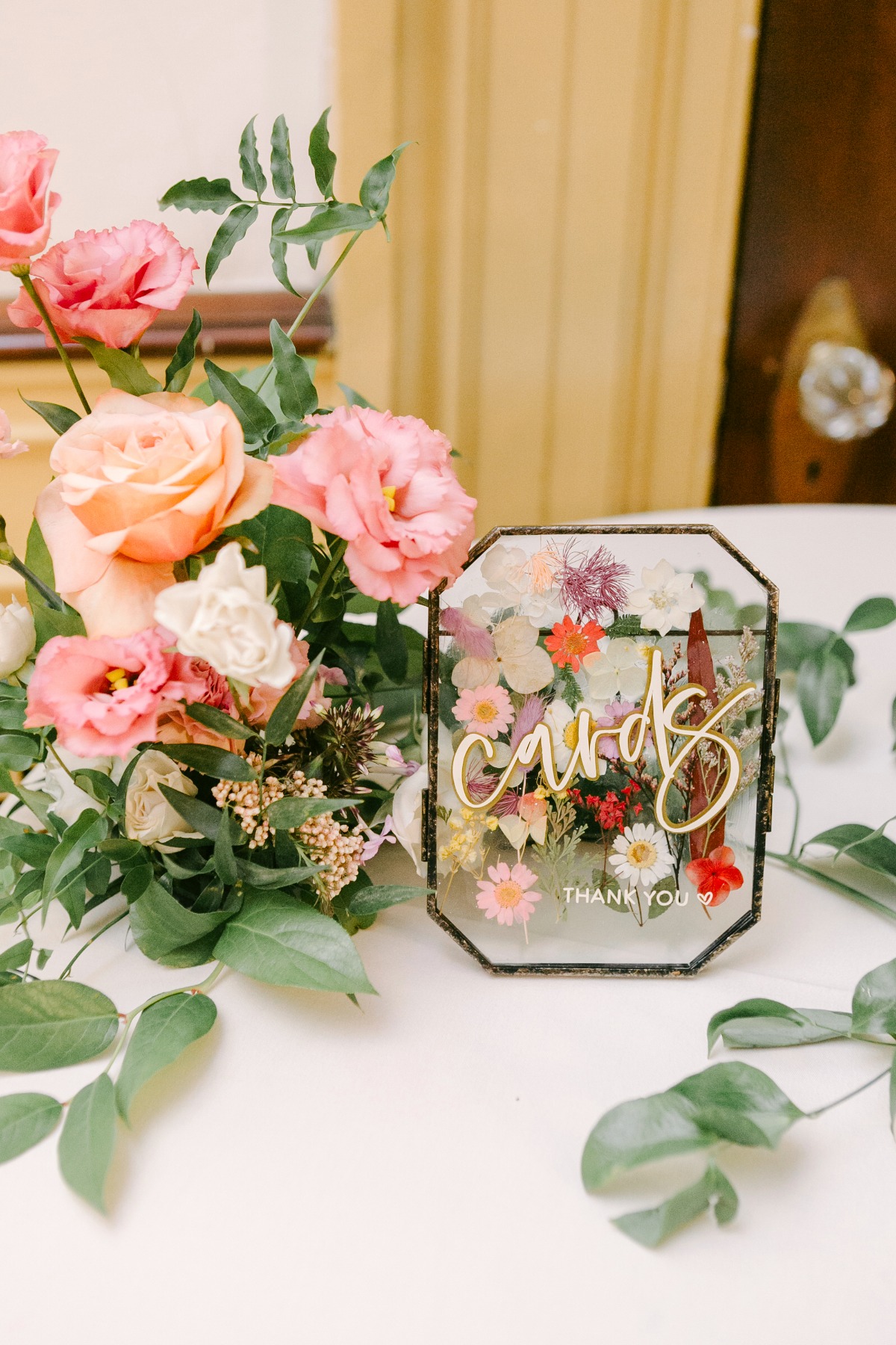 Reception card table sign with floral arrangement