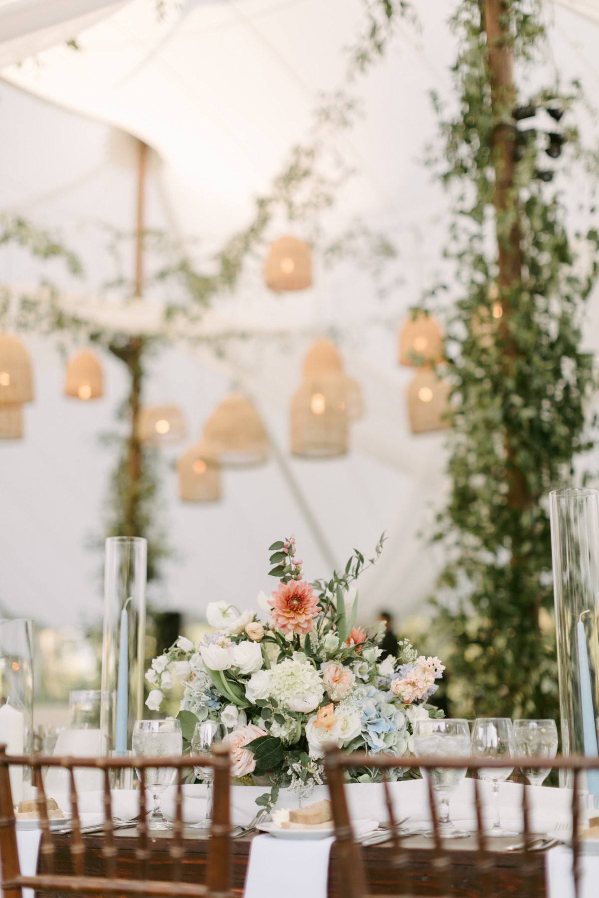 Floral centerpiece with white, pink, blue, and pops of pink-orange flowers