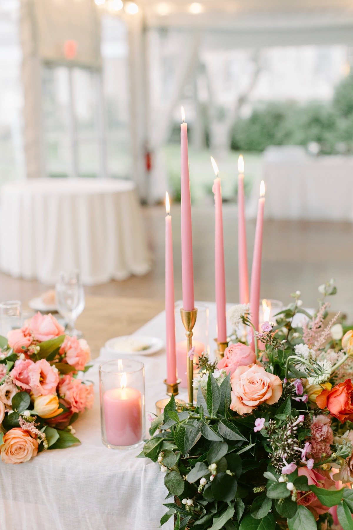 Reception table floral centerpieces with pink candles