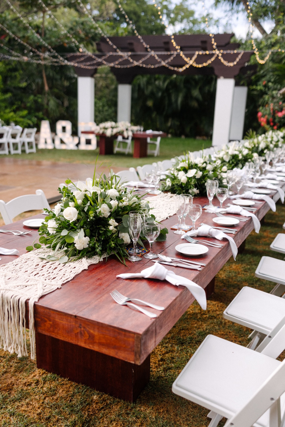 Reception table with white flowers and greenery