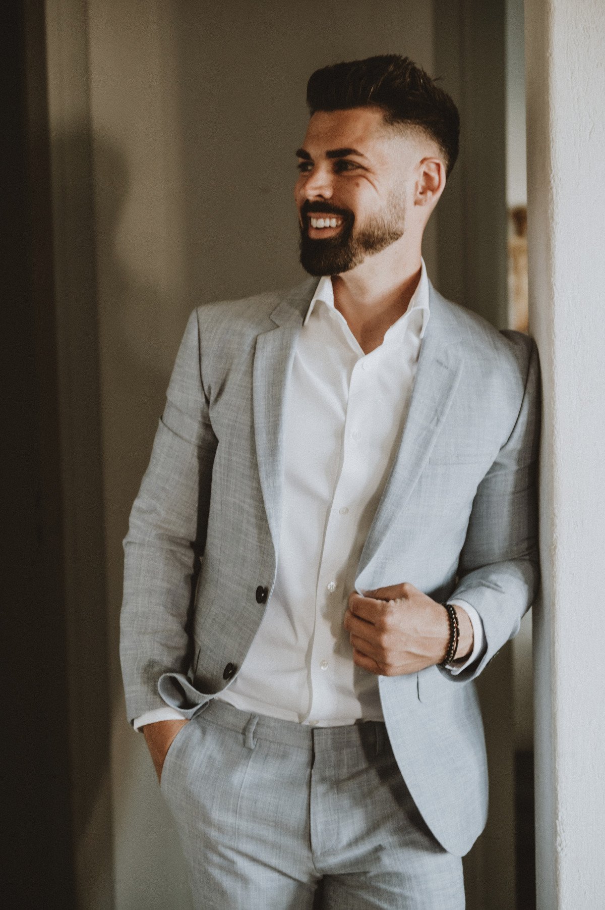 Portrait of groom in grey suit