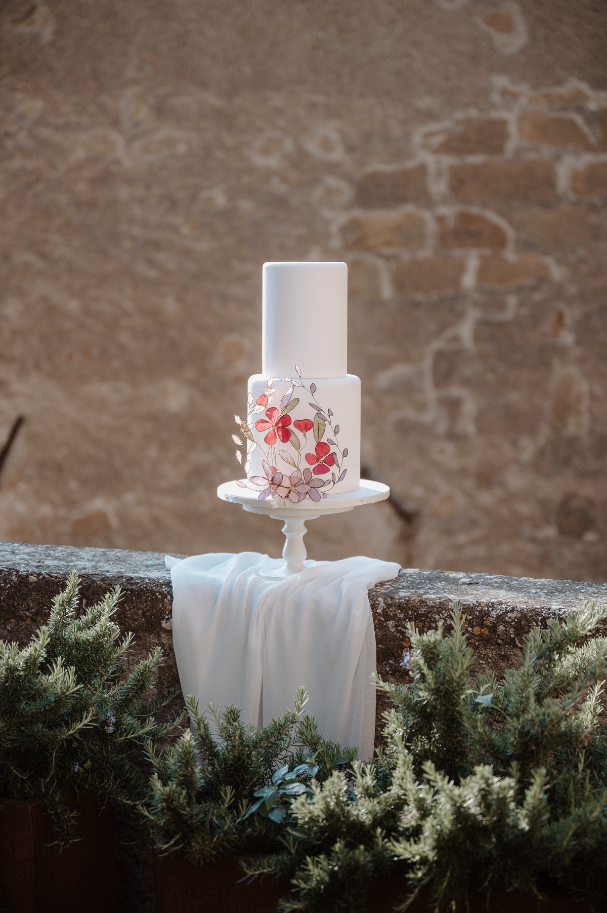 White wedding cake with handmade floral design