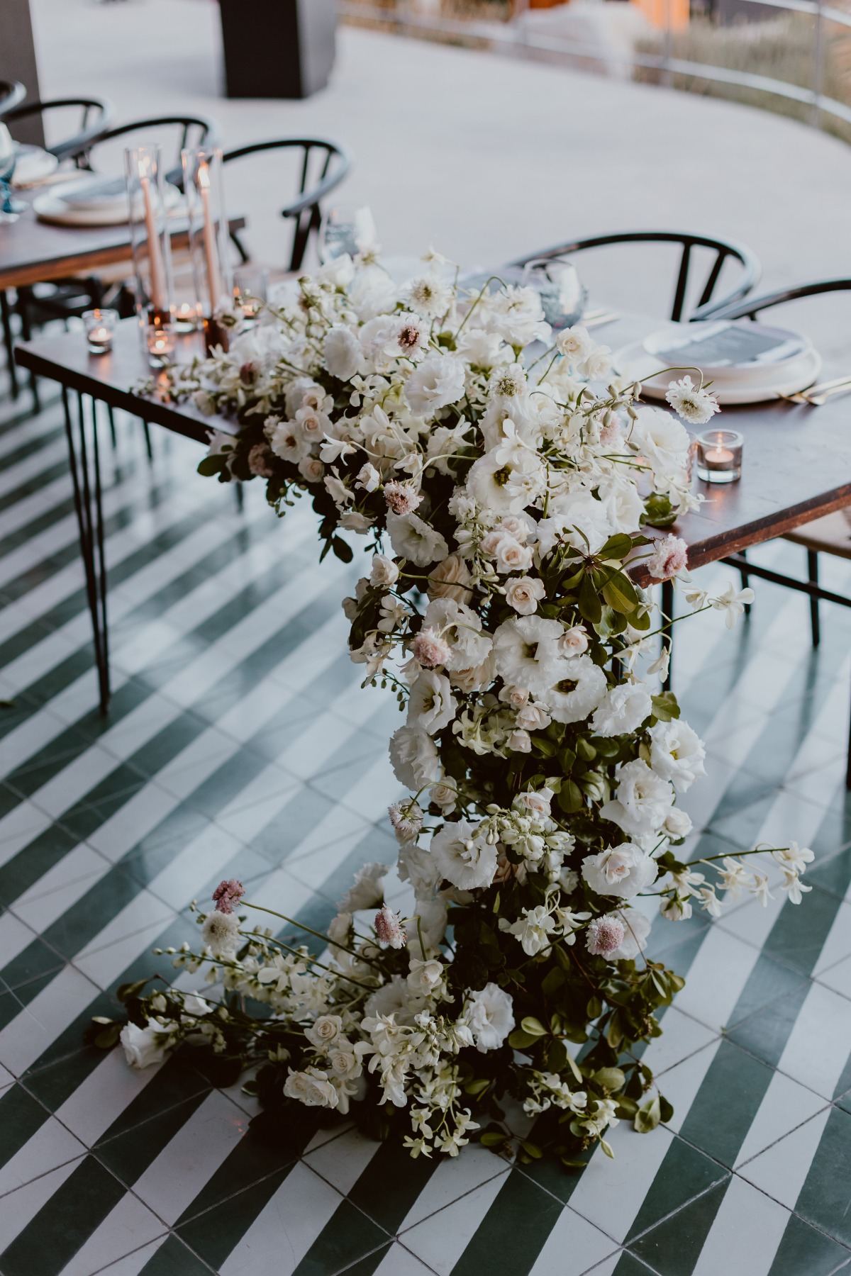 Cascading floral arrangement designed by Let It Bloom