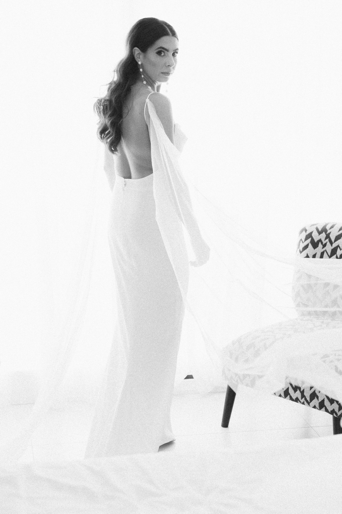 Bridal portrait with open back dress and tulle cape