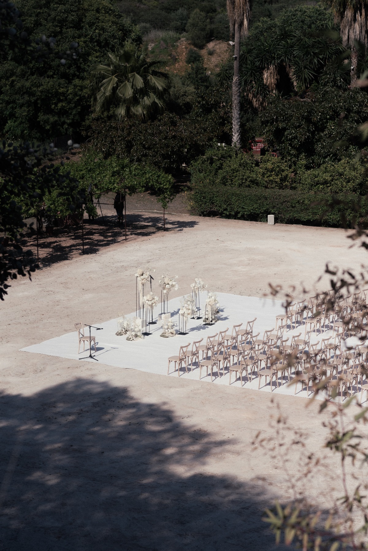 Aerial view of ceremony space with chairs and tall floral arrangements