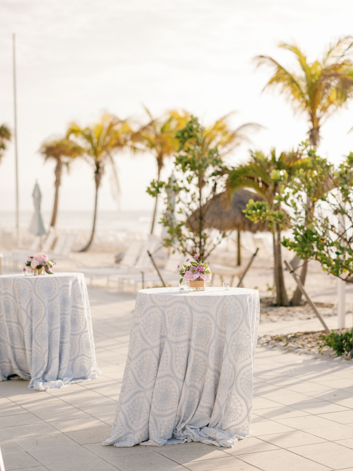 Cocktail hour tables with tableclothes and centerpieces