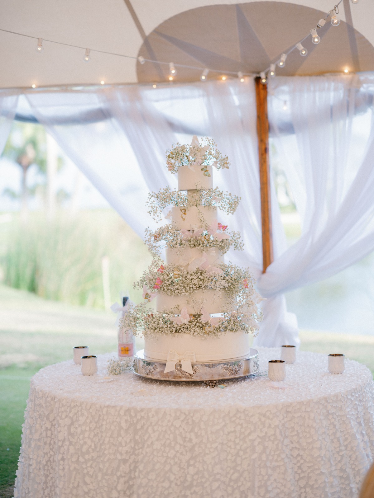 Wedding cake accented with baby's breath and roses