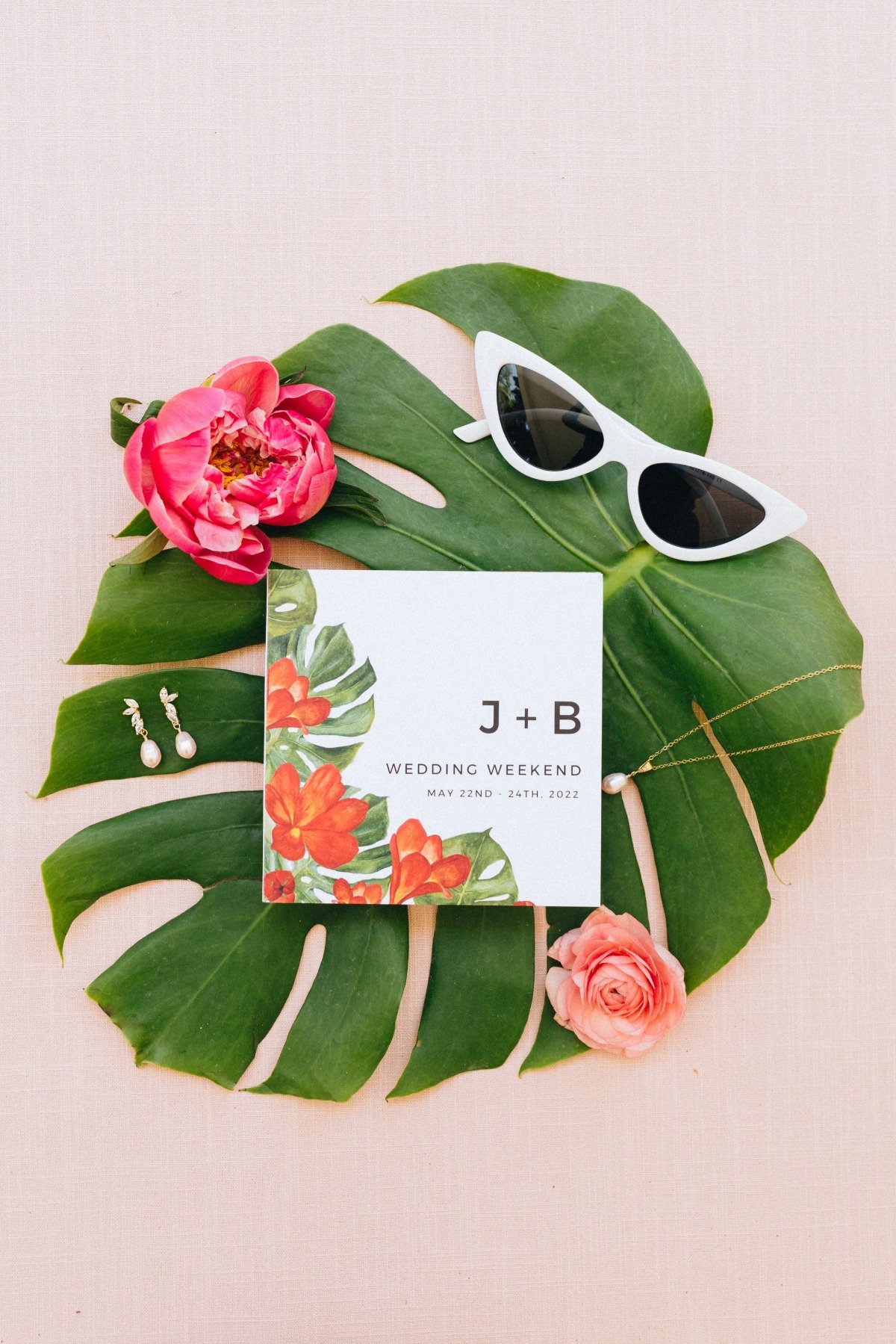Invitation, tropical flowers, sunglasses, and earrings