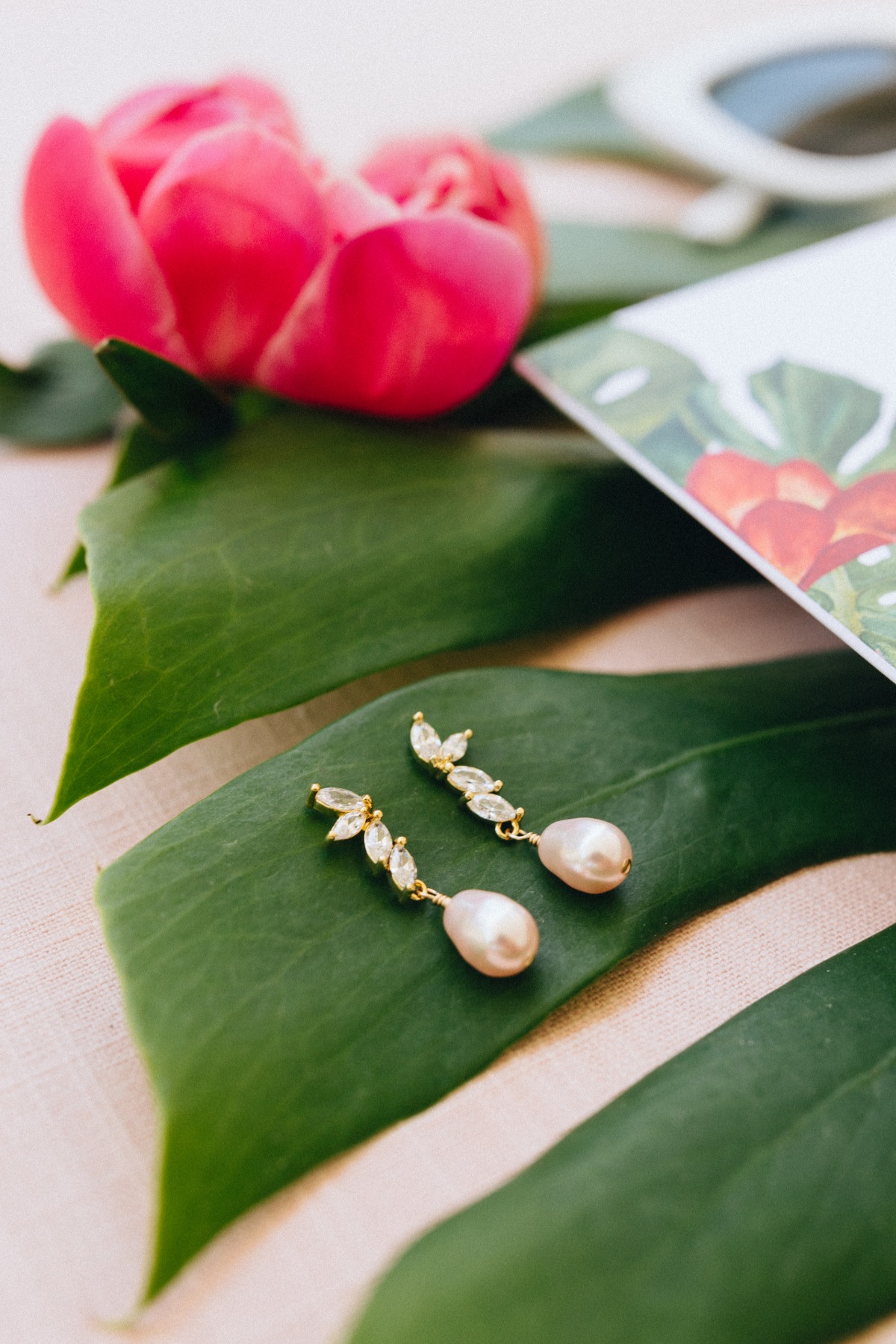 Wedding earrings on monstera leaf