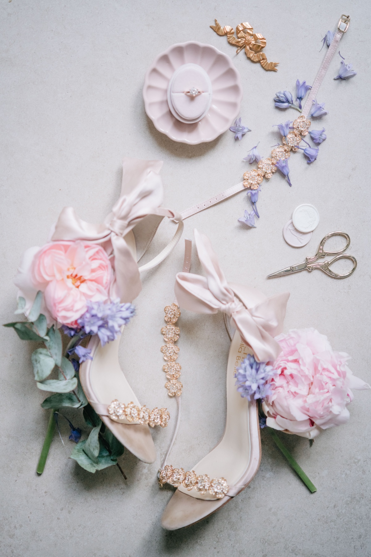 Aerial view of rhinestone wedding sandals and florals