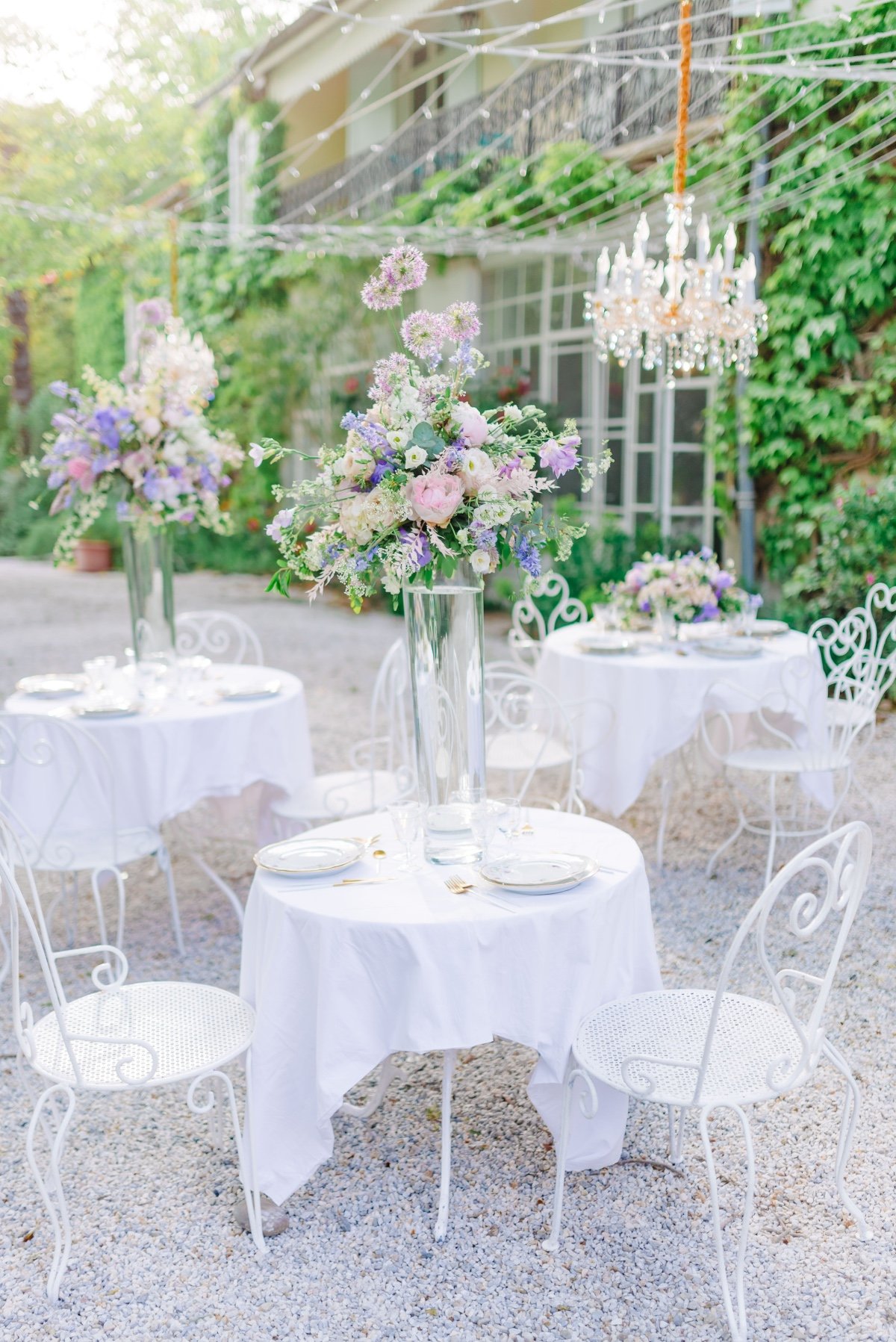 Reception tables with centerpiece and crystal chandelier