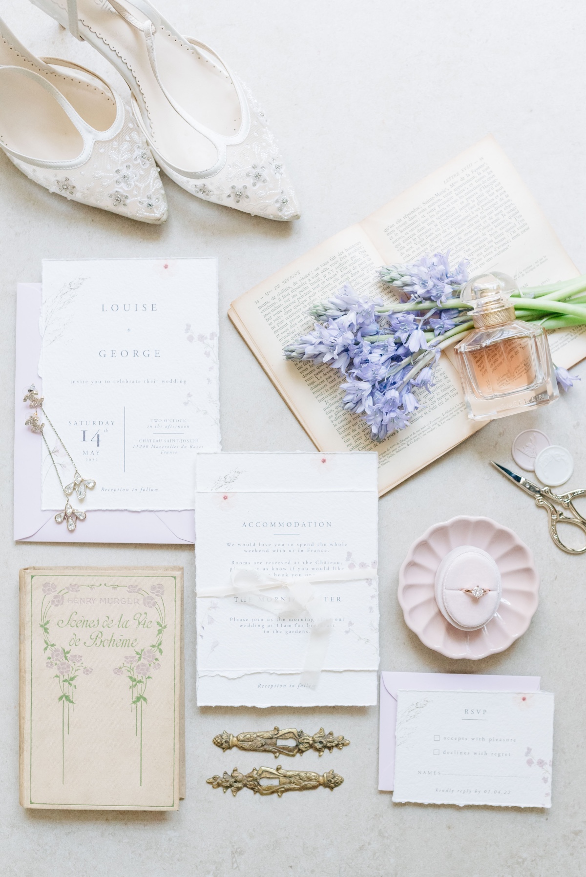 Aerial view of invitation, engagement ring, and wedding shoes