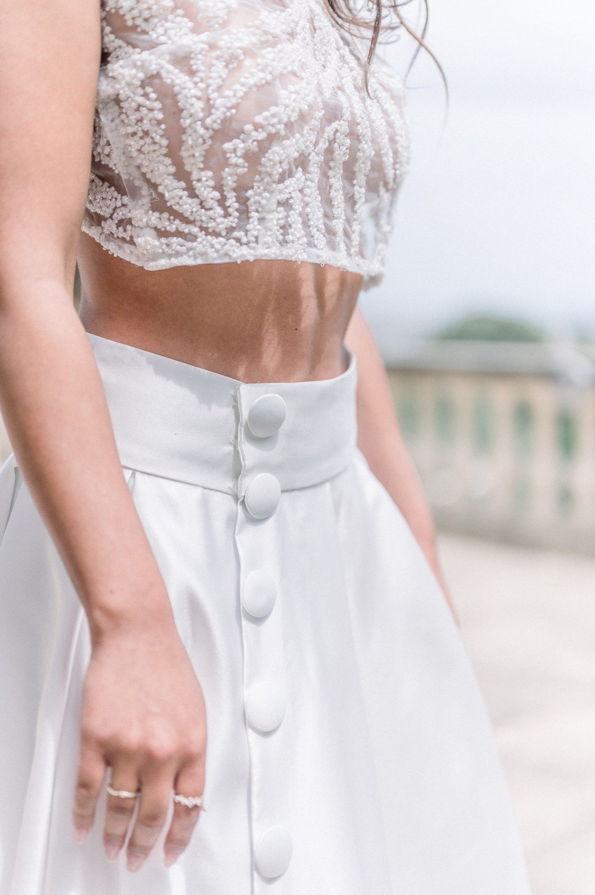 Close-up of bride's two piece gown with large buttons