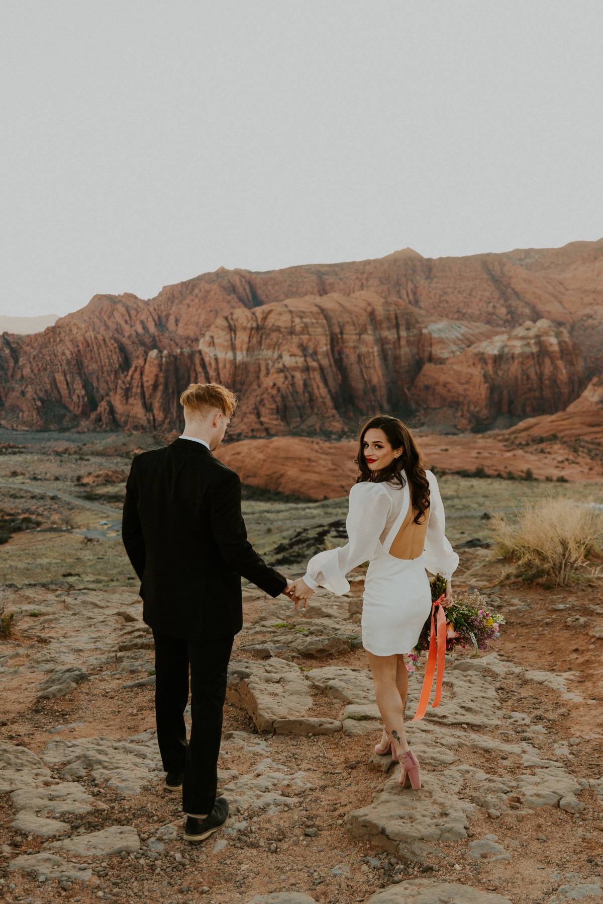 Portrait of bride and groom in front of Utah plateaus