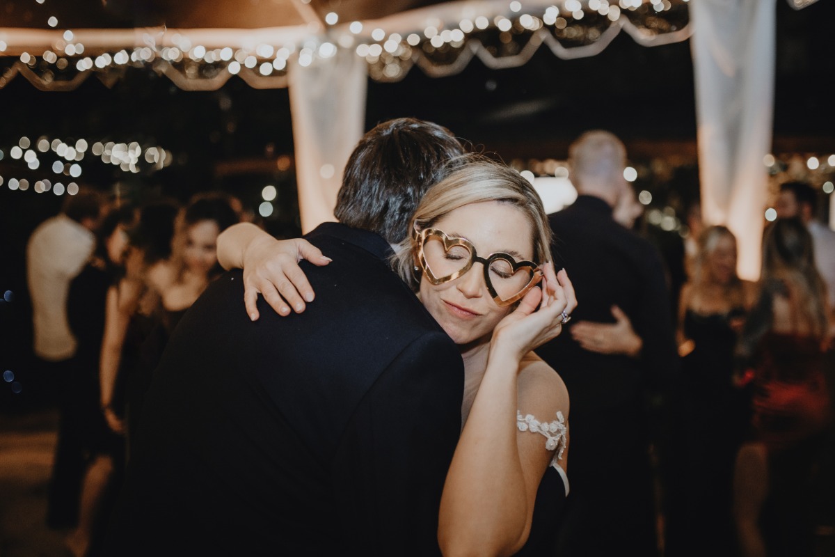 Bride in heart-shaped glasses dancing