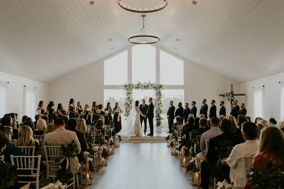 Panoramic photo of ceremony with bride and groom at altar