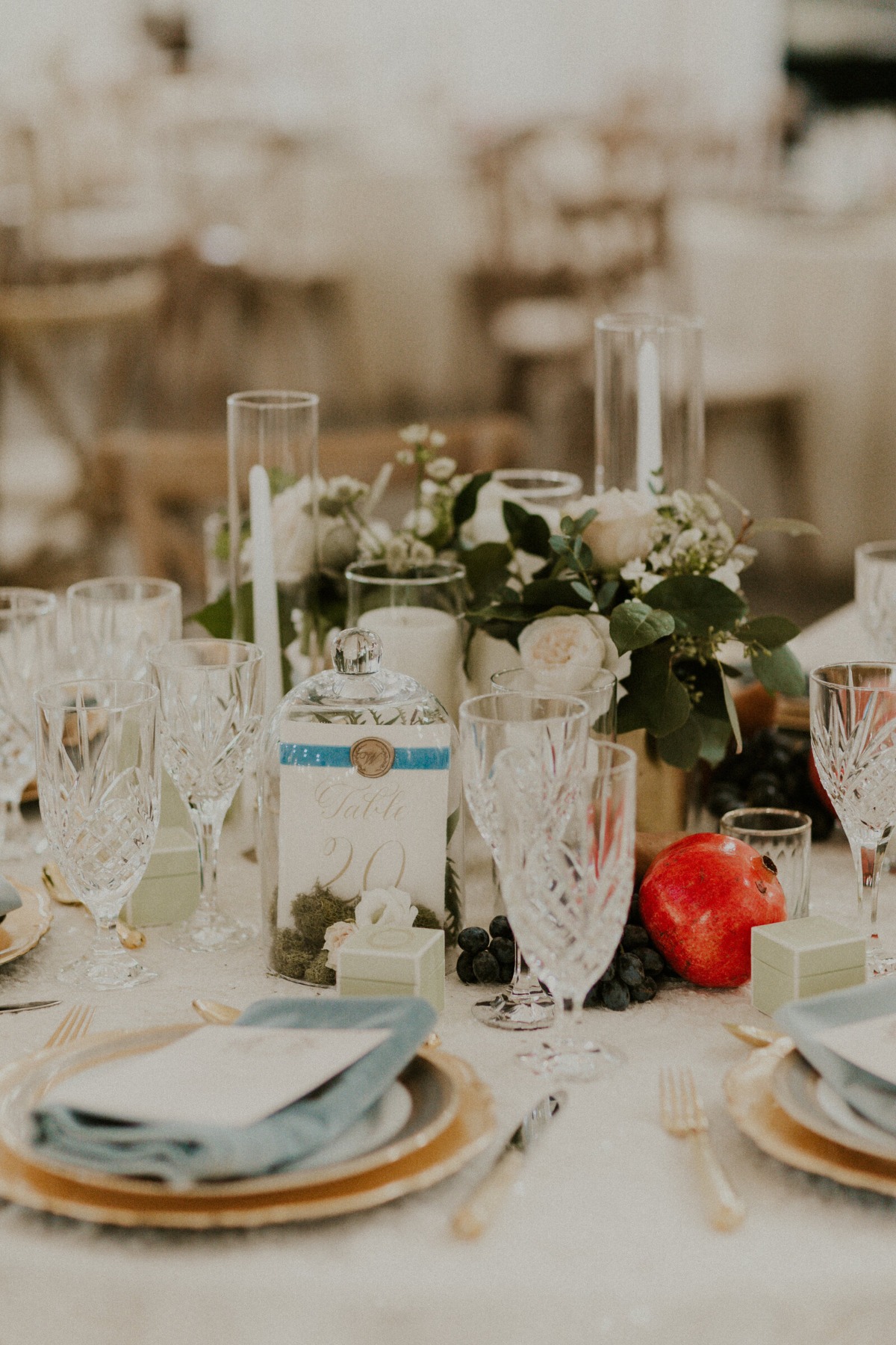 Close-up of reception centerpiece with table number and crystal glasses