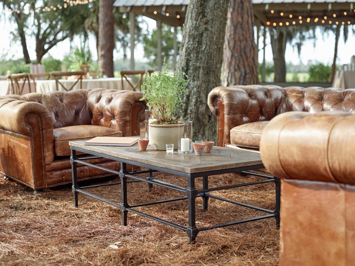 Leather couches with table with herbal centerpiece