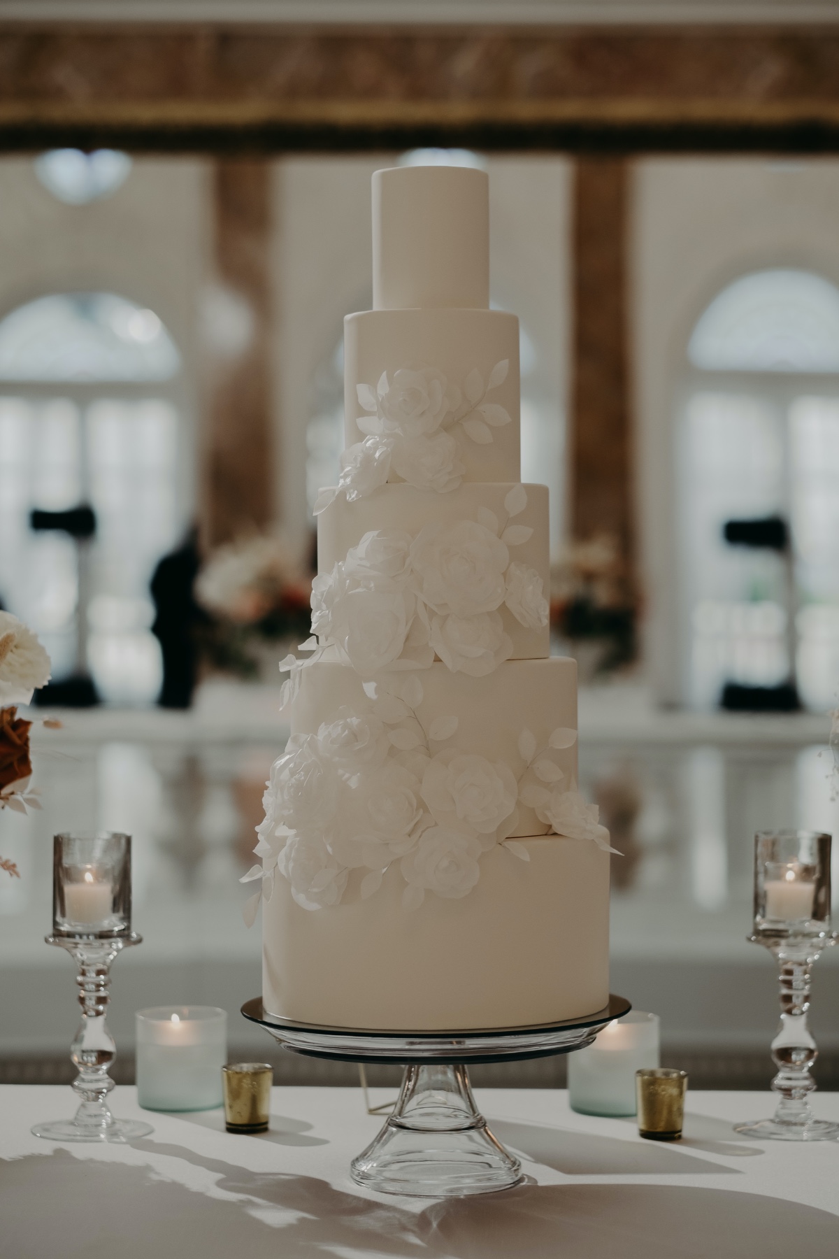 Close-up of wedding cake with white floral design