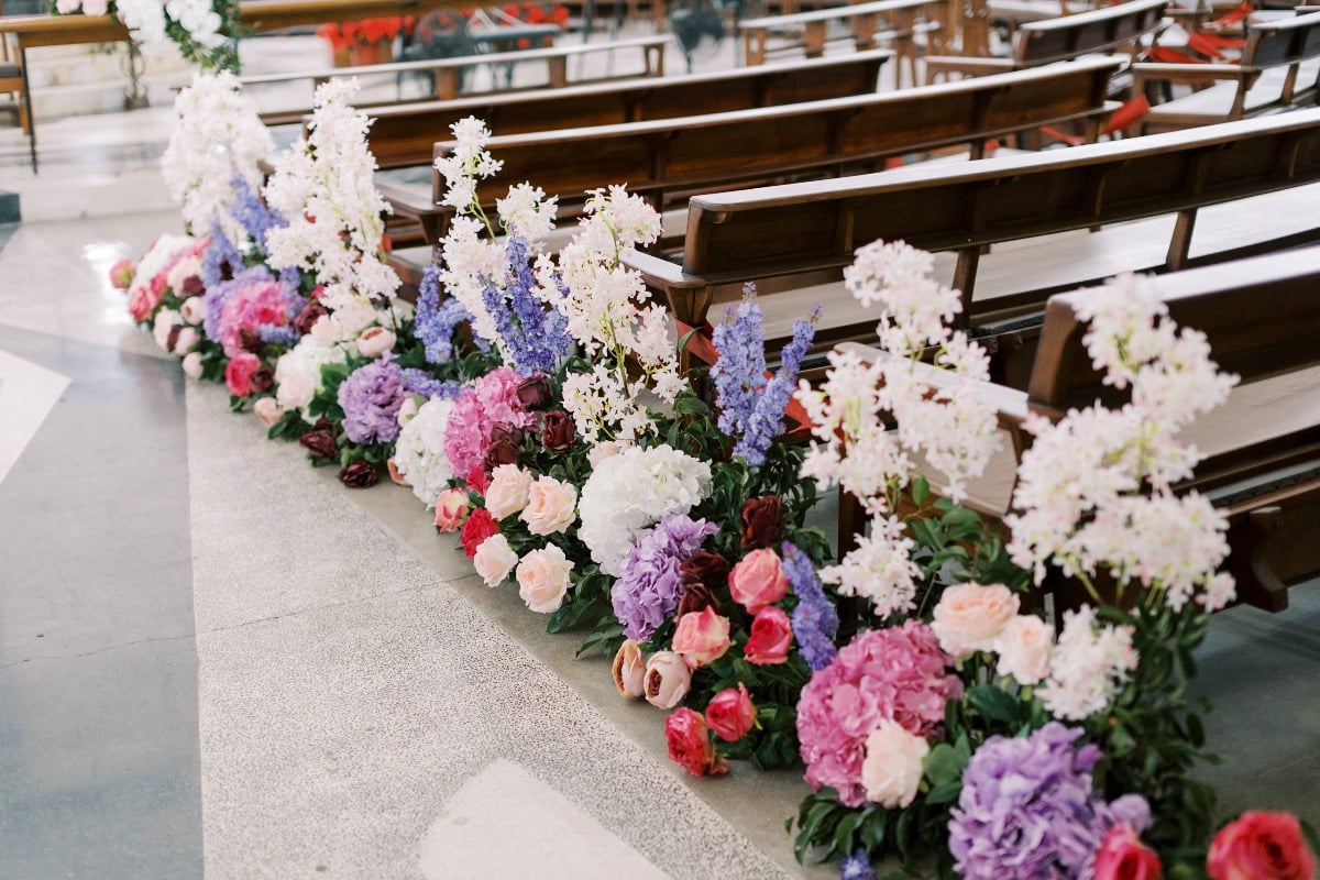 Floral arrangements on side of ceremony aisle