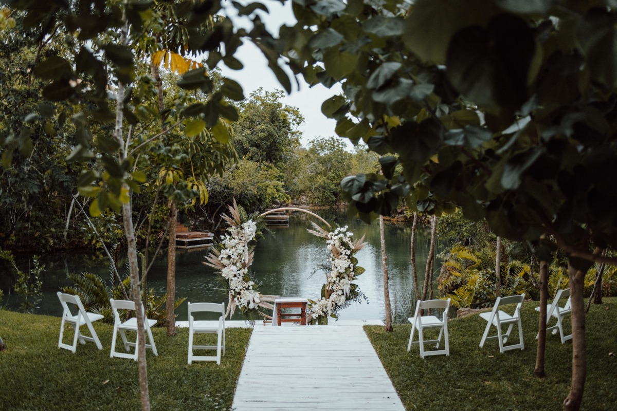 Ceremony circular altar with floral installation in front of water