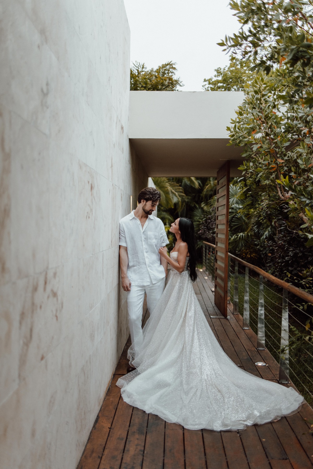 Bride and groom on deck with bride's train fully extended
