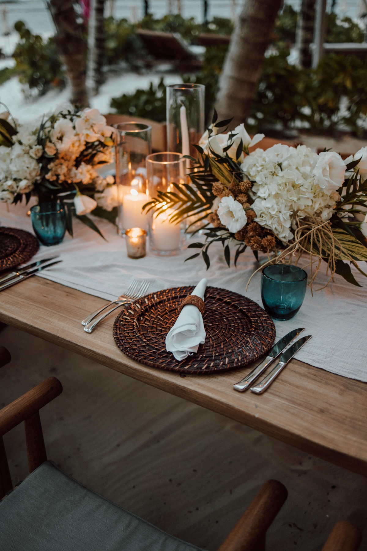 Close up of centerpieces, place settings, and candles