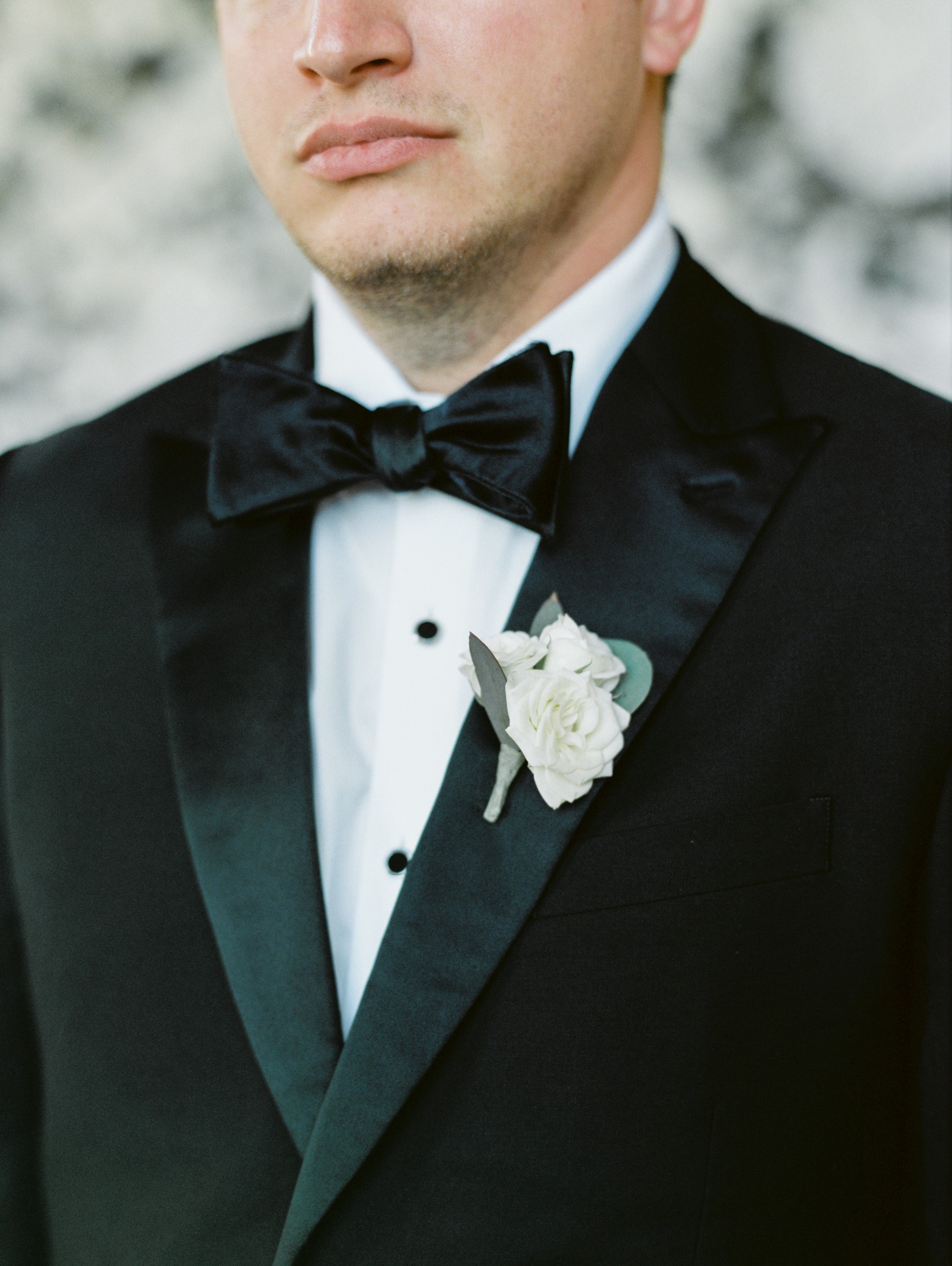groom in black tux