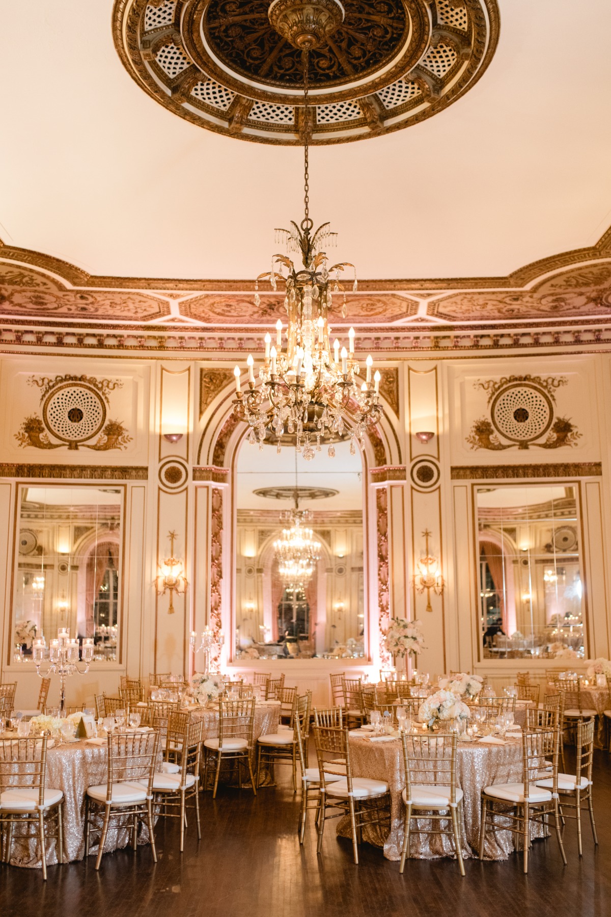 Wedding reception tables under chandelier