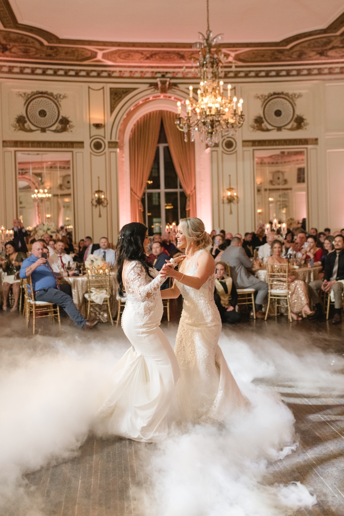 Brides having first dance surrounded by fog