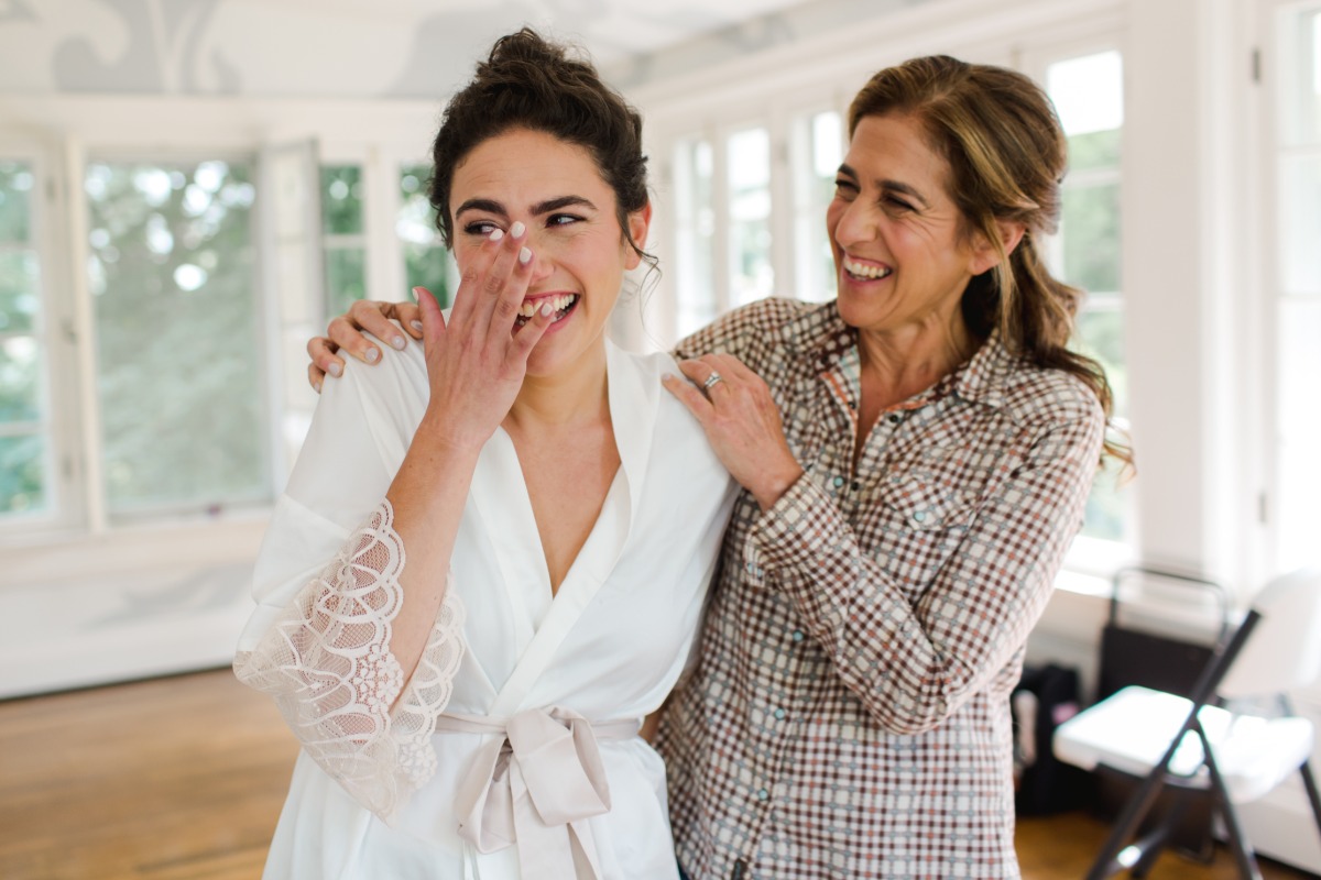 Bride in robe with mother of the bride