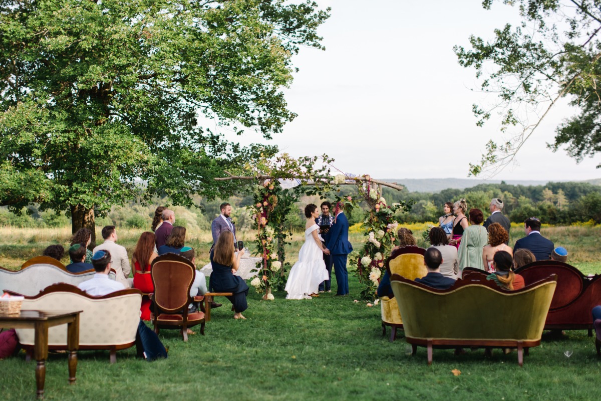 Bride and groom standing at chuppah