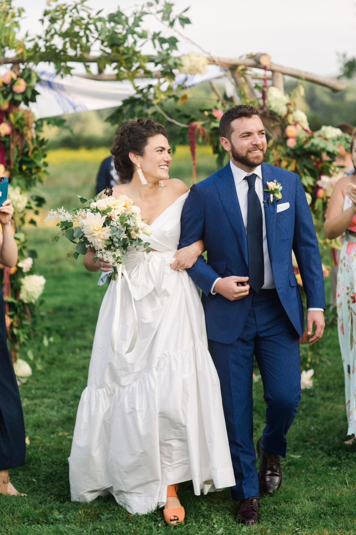 Bride and groom walking down aisle arm in arm after ceremony
